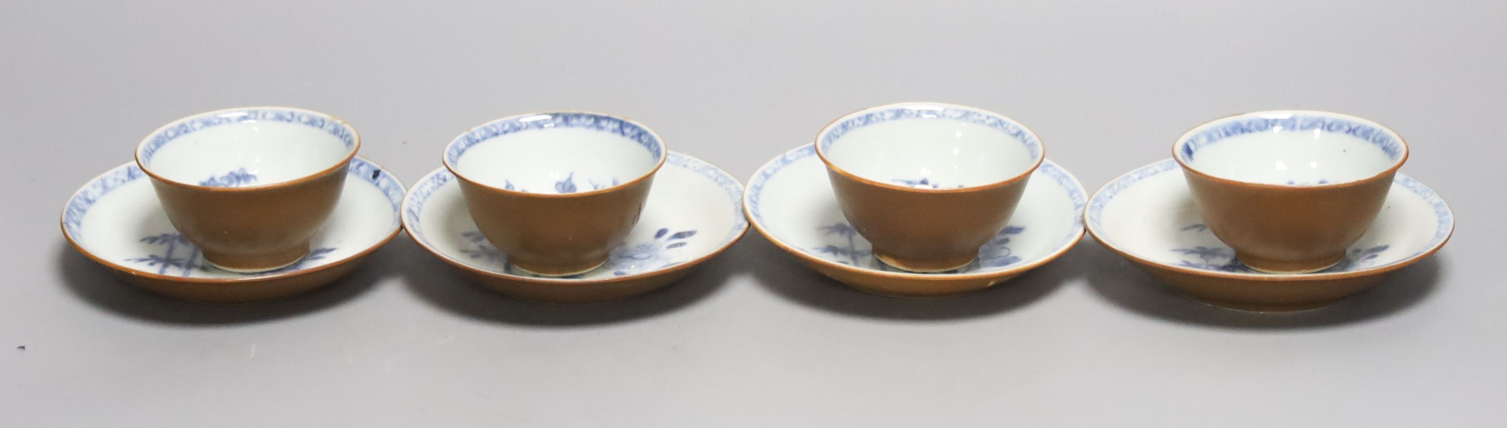 A set of four Chinese Nanking Cargo blue and white teabowls and saucers, with cafe au lait ground